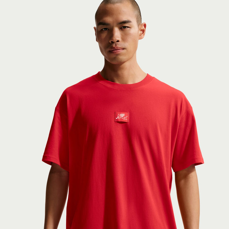 Men's red crew-neck T-shirt with small chest logo, close-up.