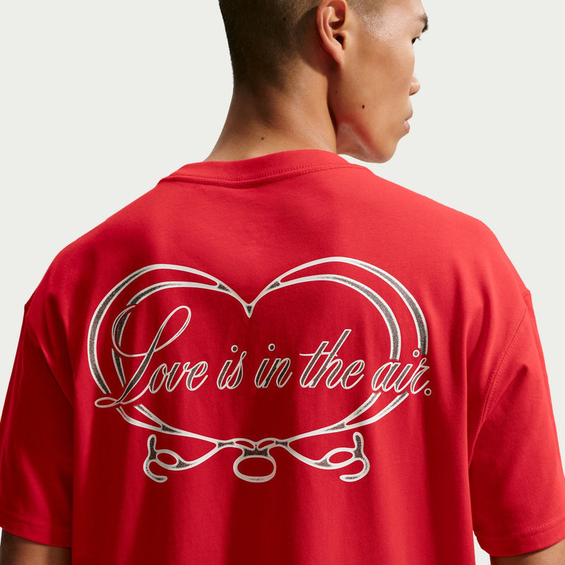 Back graphic heart with cursive 'Love is in the air' on men's red T-shirt.