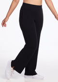 The person is wearing Luca Ribbed Pants by Woolx in black and white sneakers, shown from the waist down, walking with a slight bend in the left leg against a plain white background. | Sarah is 5'8", wearing a size S