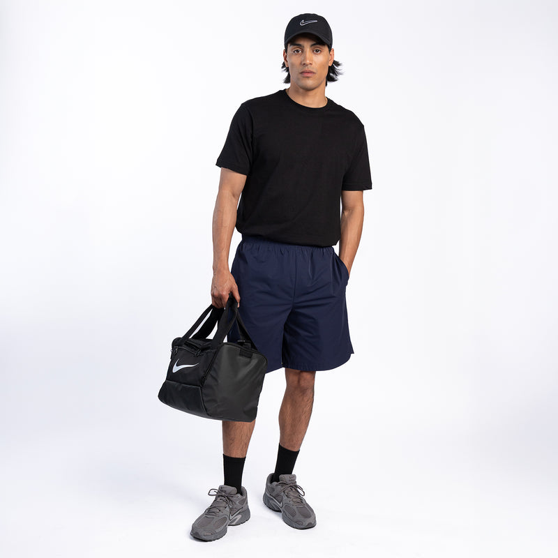 Men's navy woven shorts on model, elastic waist and side seam detail.