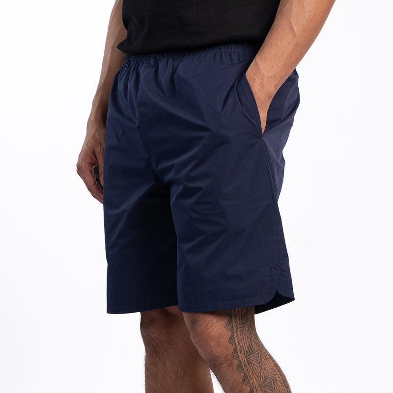 Men's navy woven shorts, side view, knee-length with relaxed fit.
