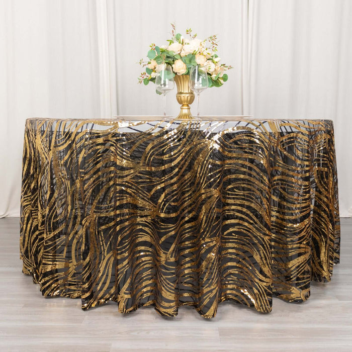 Gold and black patterned tablecloth with floral centerpiece on a table.