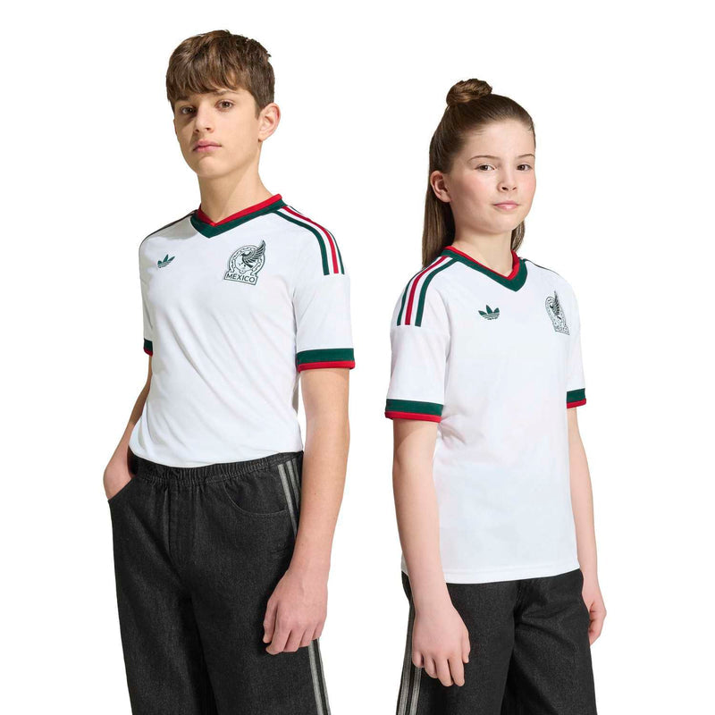 Youth white Mexico away soccer jersey with crest, green trim, and red-striped shoulders