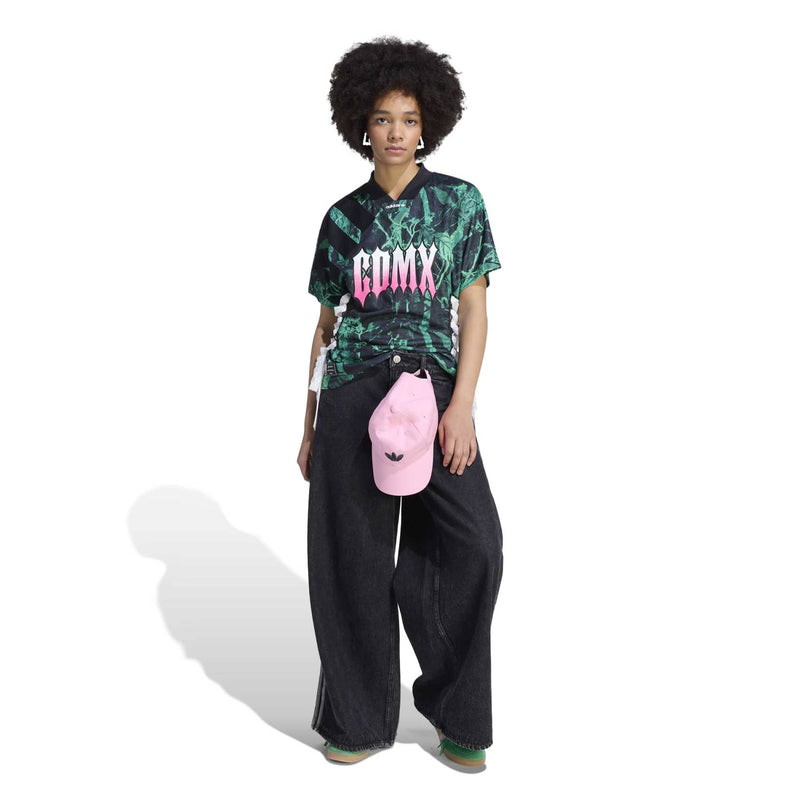 Women's green-black graphic jersey with pink 'COMX' logo, short sleeves