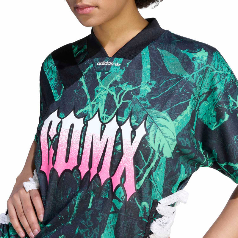 Women's graphic jersey with green leaf print, pink letters, black collar, adidas logo