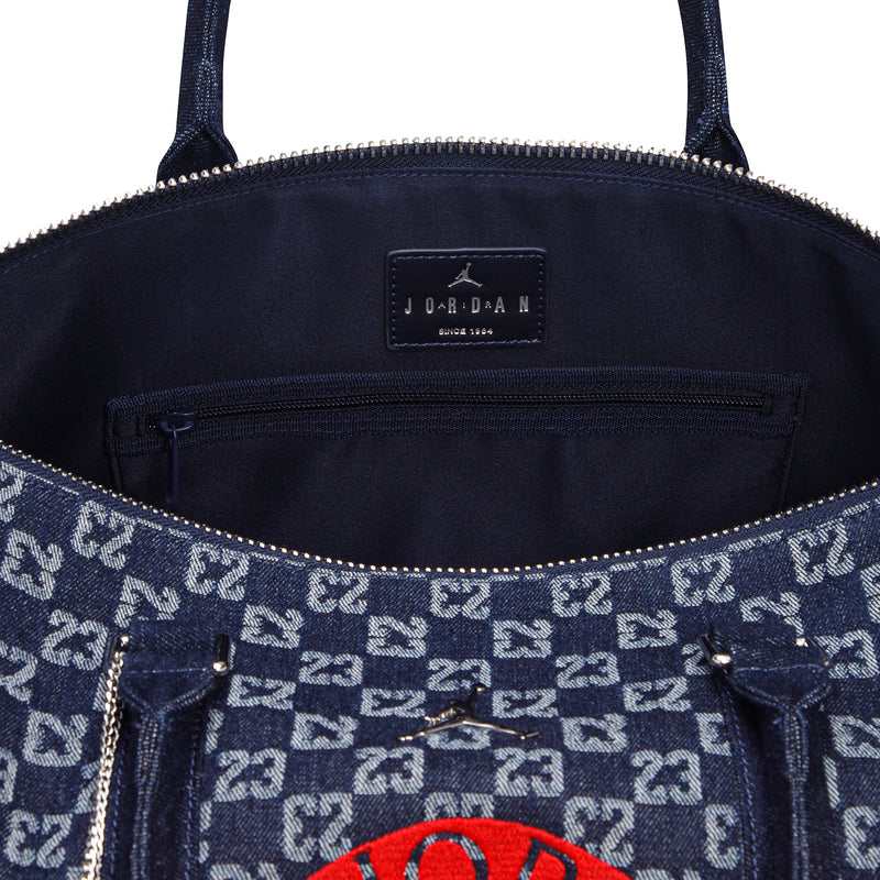 Dark indigo monogram duffle bag interior with JORDAN label and zipper