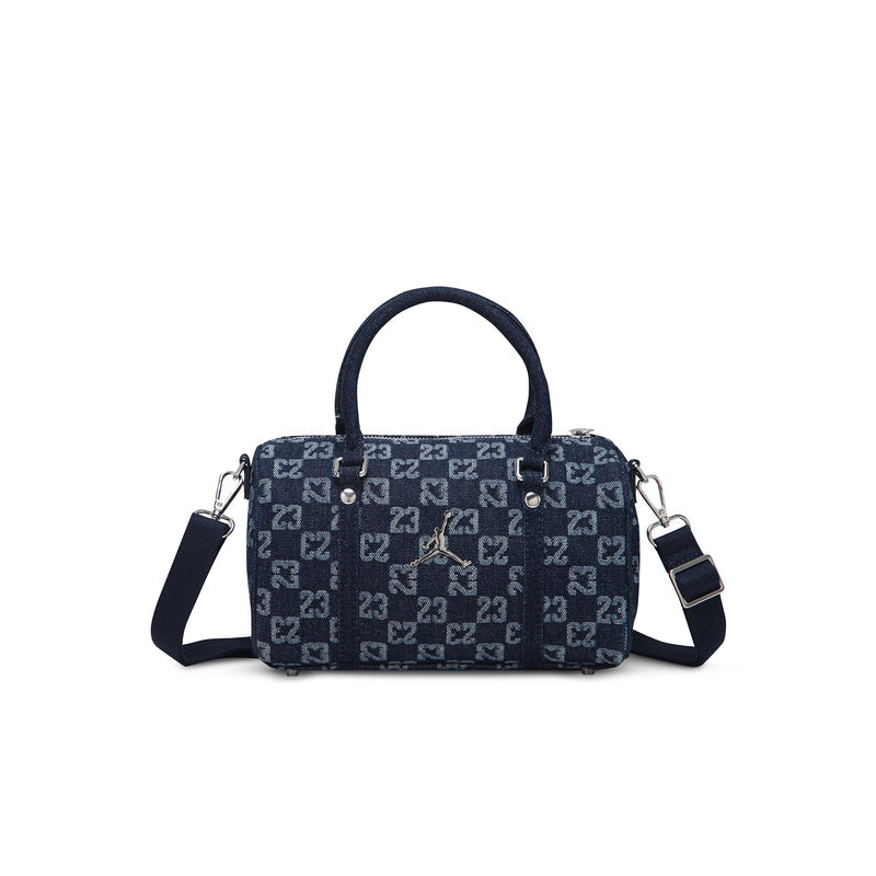 Dark indigo monogram mini duffle bag with red emblem, zip top, and crossbody straps
