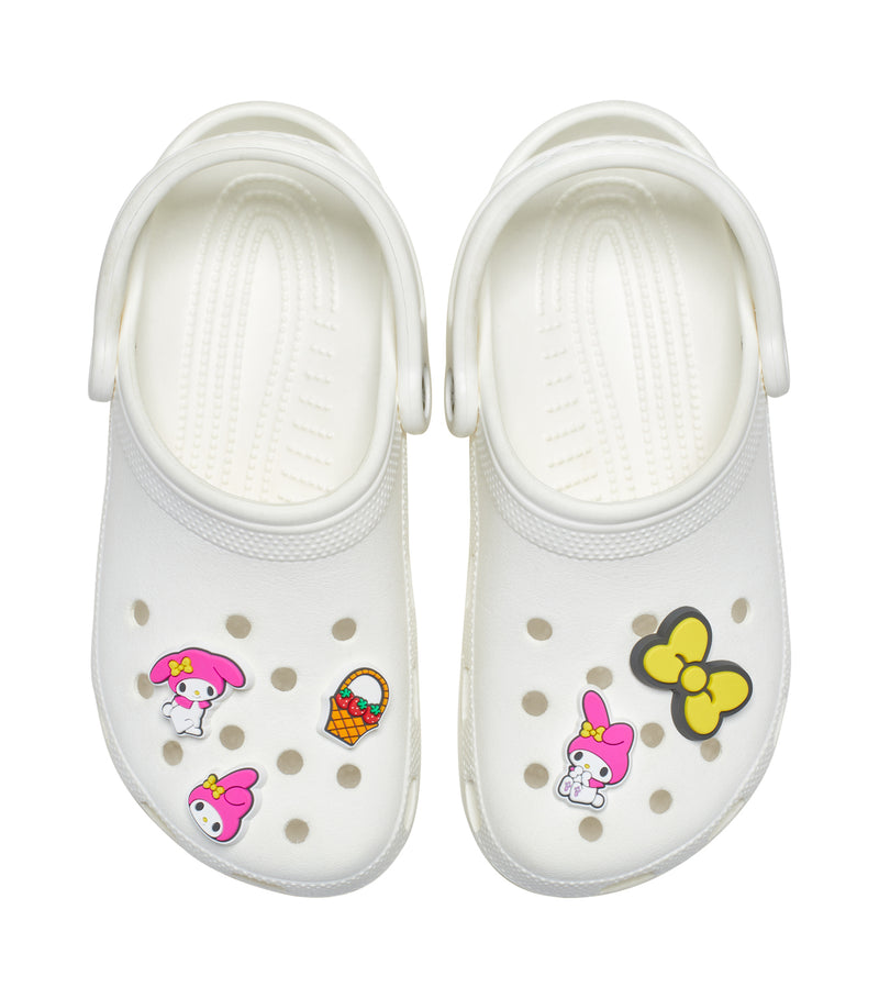 White Crocs with five MyMelody jibbitz charms: bunny faces, yellow bow, and basket
