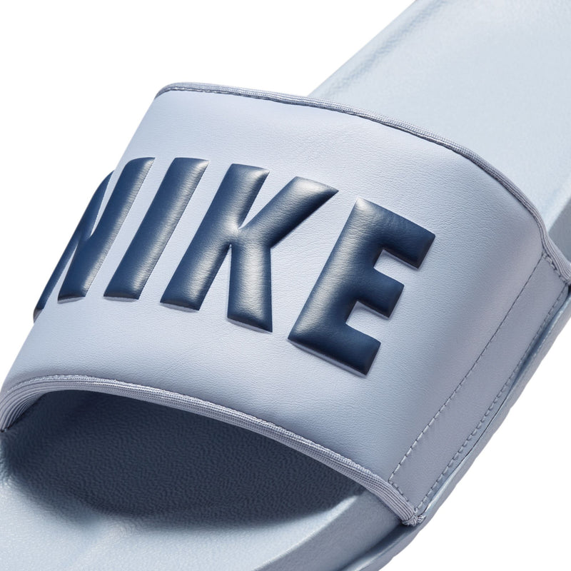 Close-up of light blue slide sandal strap with NIKE logo