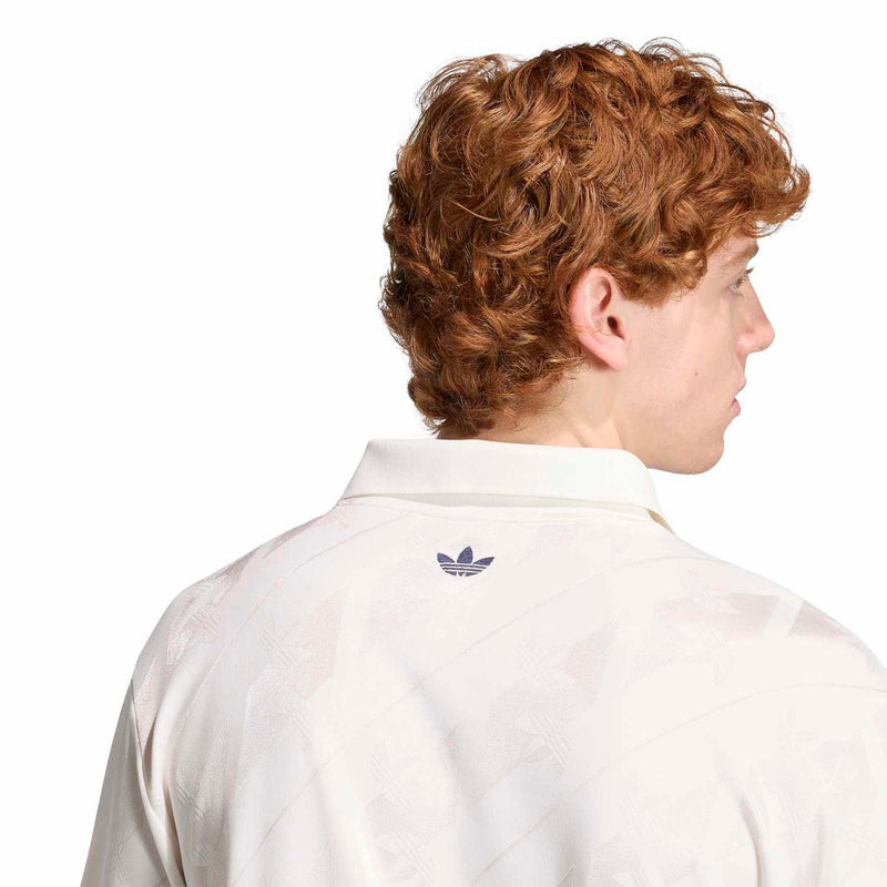 Men's white jacquard polo shirt back with small Adidas trefoil near collar