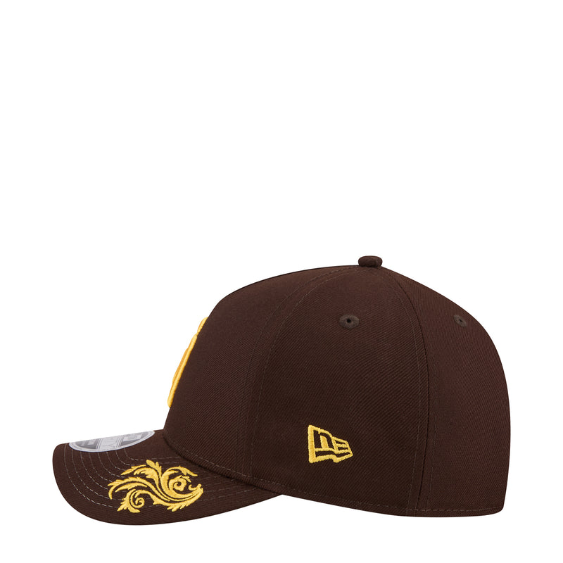 Brown baseball cap with small New Era logo at side and gold decorative brim art
