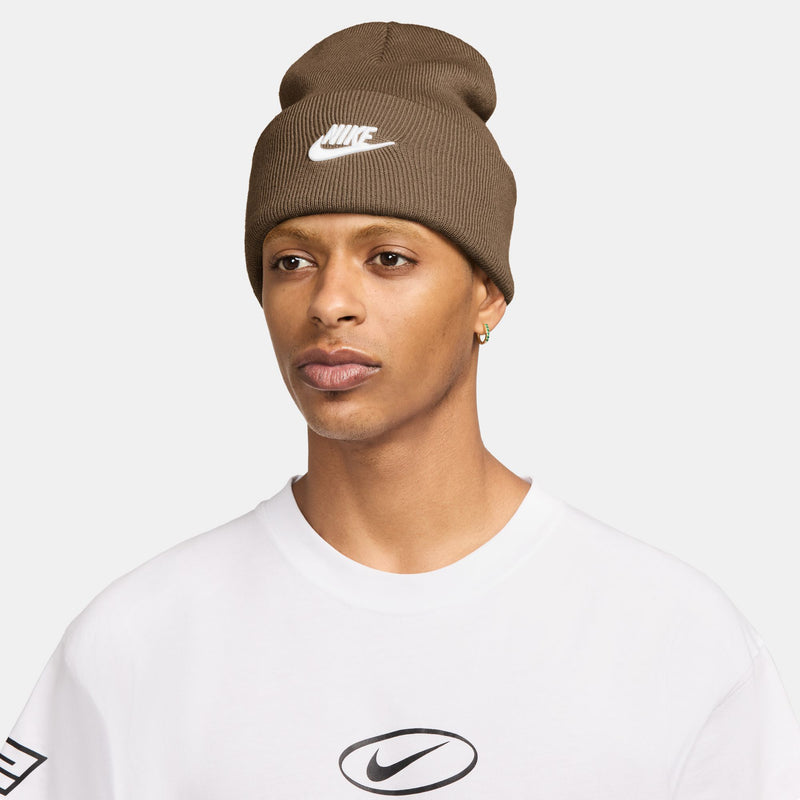 Brown knit beanie with folded cuff and white Nike swoosh logo at center