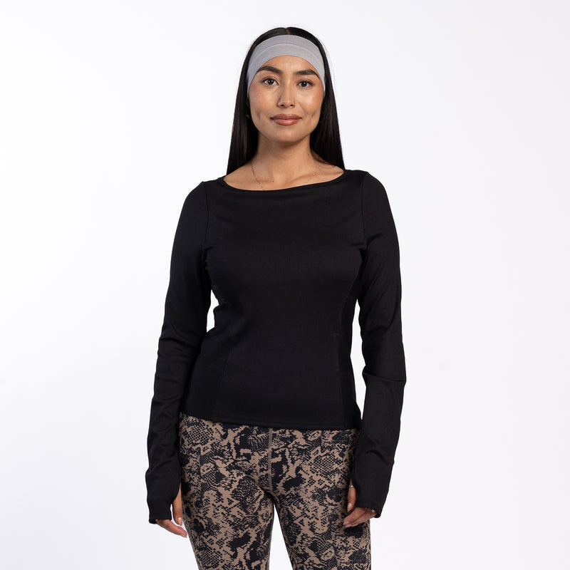 Black long-sleeve ribbed women’s top on model, crew neck, fitted waist