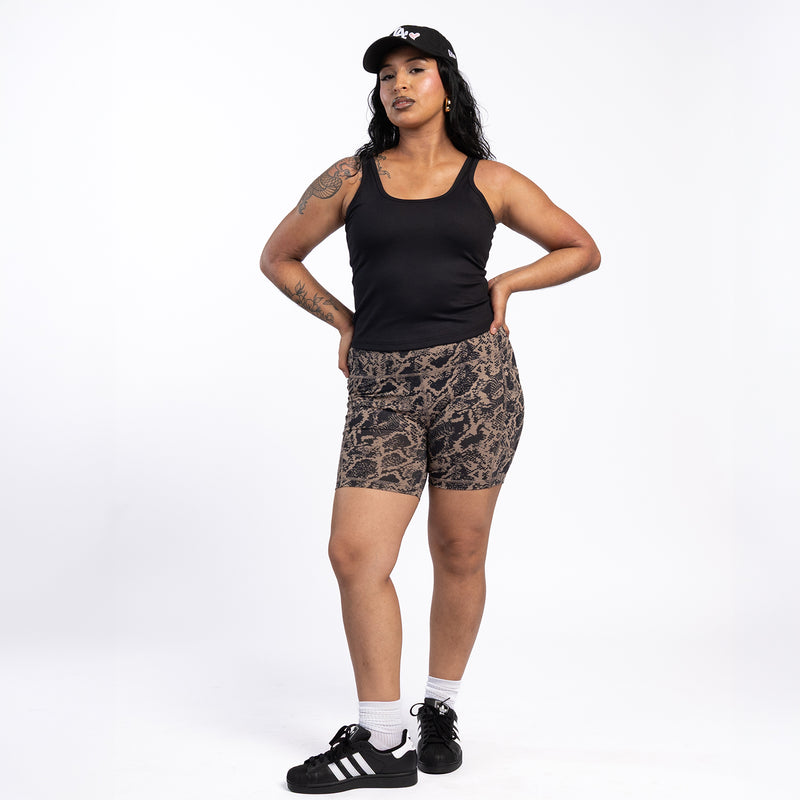Womens black ribbed sport tank top with scoop neck, worn with athletic shorts