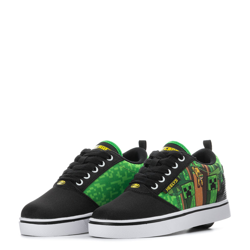 Pair of youth black sneakers with green trim and Minecraft-style side graphics