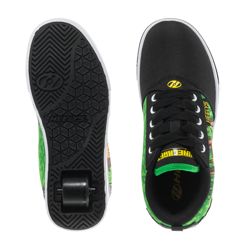 Youth sneaker showing outsole and upper, black with green accents