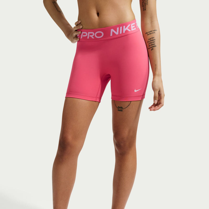 Womens pink Nike Pro 5" shorts on model, straight hem and side swoosh