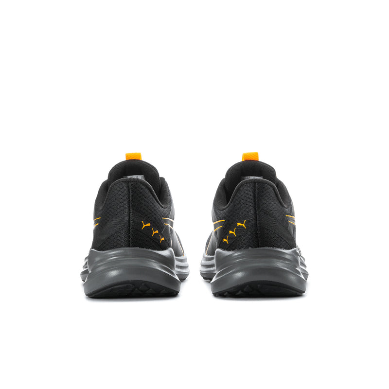 Men's black sneakers with yellow heel tabs and molded rubber outsole, rear view
