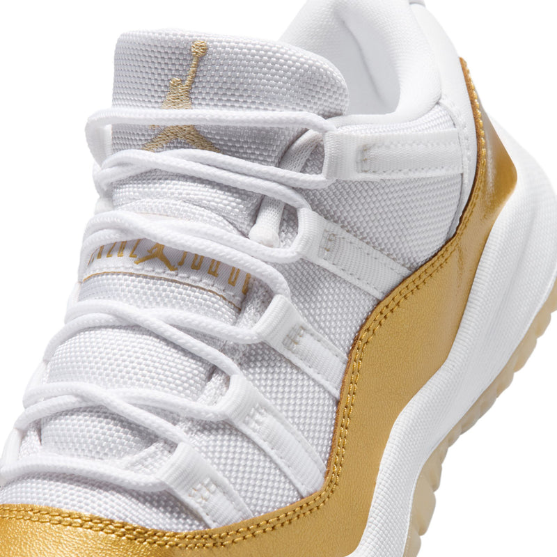 Kids sneaker close-up: white mesh upper with gold stitch accents and laces