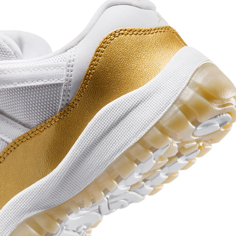 Kids sneaker close-up of gold side and white outsole with traction pods