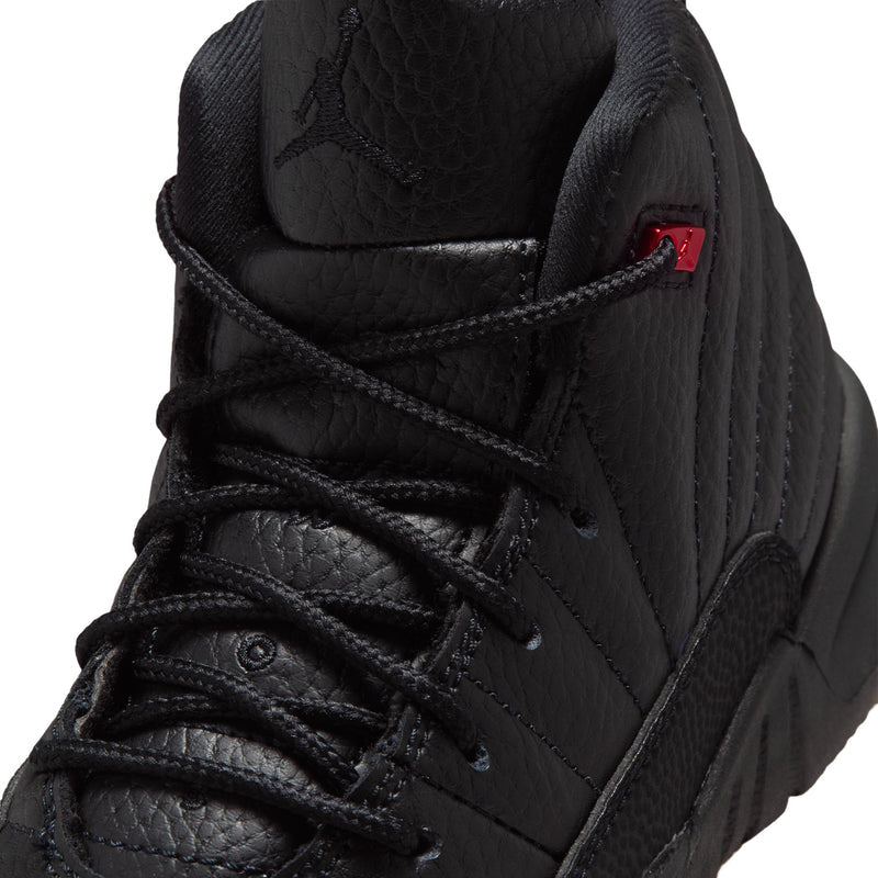 Kids black high-top sneaker close-up: textured upper, laces, and small red logo