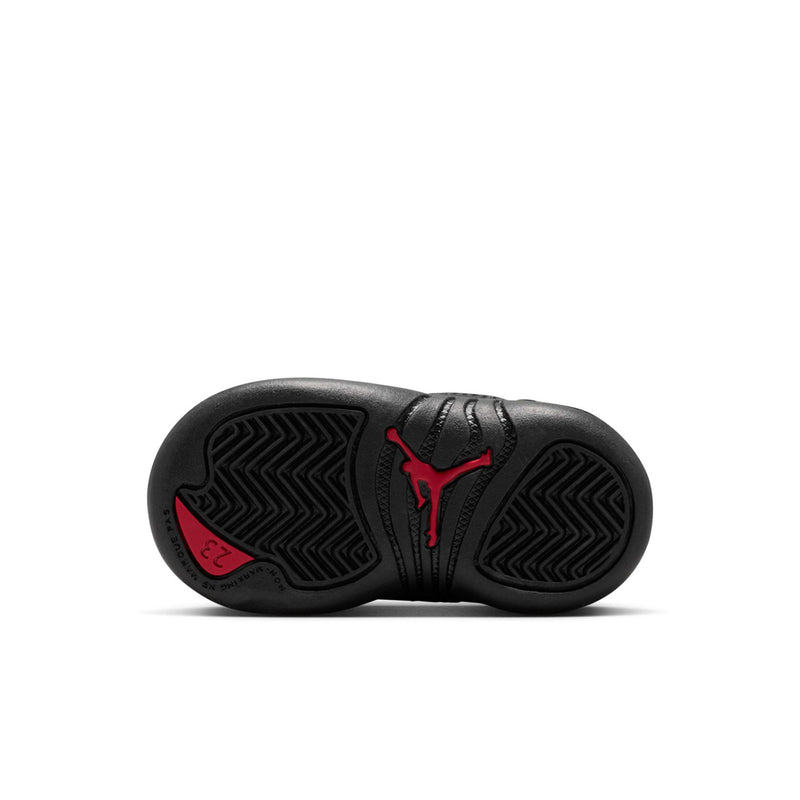 Black toddler sneaker outsole with red Jumpman-style logo and zigzag tread