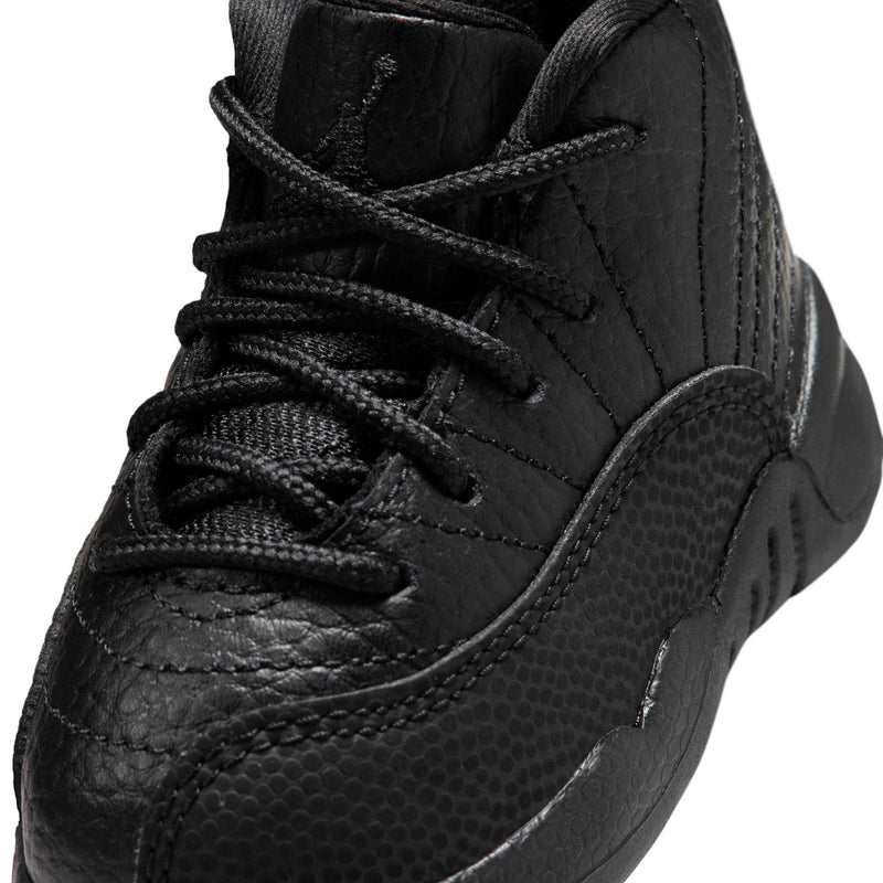 Black toddler high-top sneaker close-up with lace-up, textured leather, and stitching