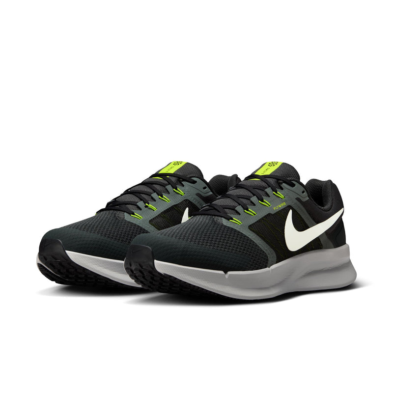 Pair of men's black running shoes with white sole and neon green trim