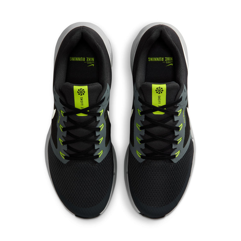 Men's black sneakers with neon green logo on insides and black laces