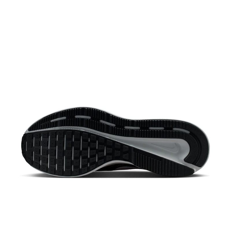 Outsole view of men's black running shoes with tread pattern and gray edge