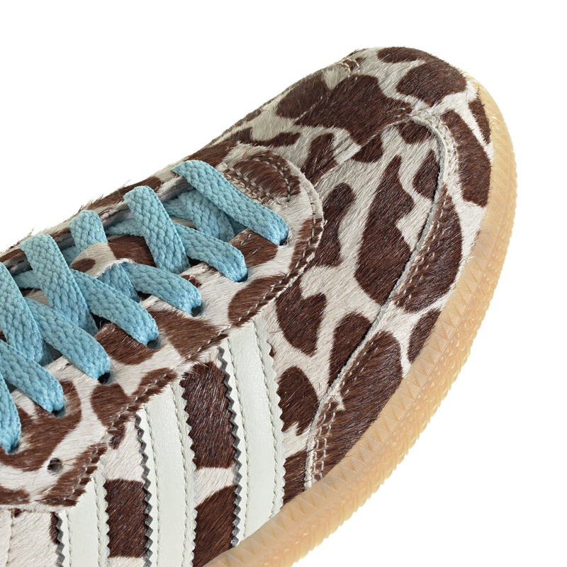 Leopard-print upper close-up with blue laces and white three-stripe detail