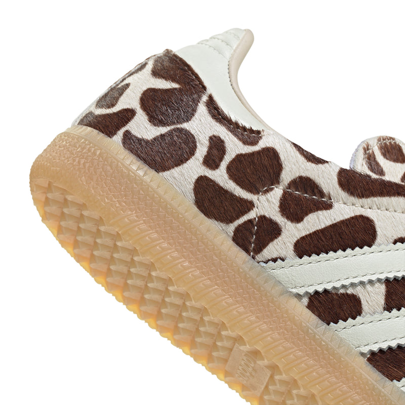 Leopard-print toe and side with blue laces, white stripes, and gum sole edge