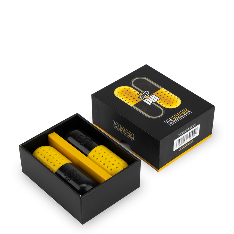 Sneaker freshener pill capsules in open black box, yellow with black caps