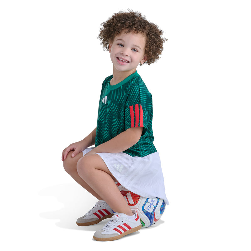 Kids green soccer skort set, side view: adidas tee with white skort