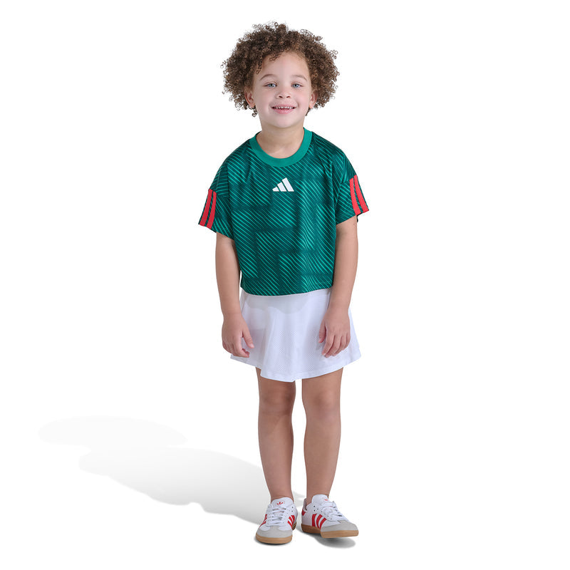 Kids green soccer skort set, full front view: adidas tee and white skort