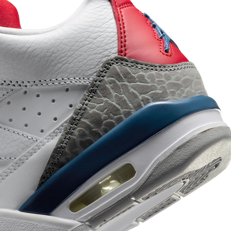 Close-up of youth sneaker side with red leather panel, gray textured toe, and air window