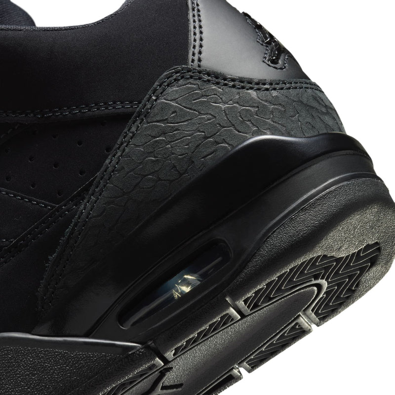Black youth basketball shoes, close-up of side panel texture and branding