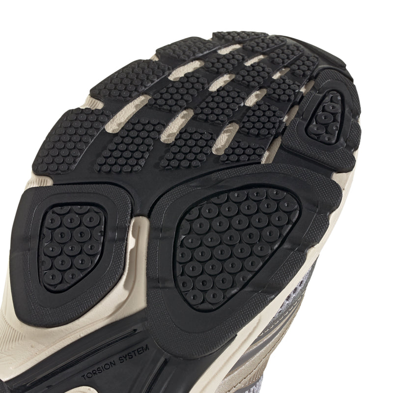 Men's running shoe outsole tread close-up with round traction pods
