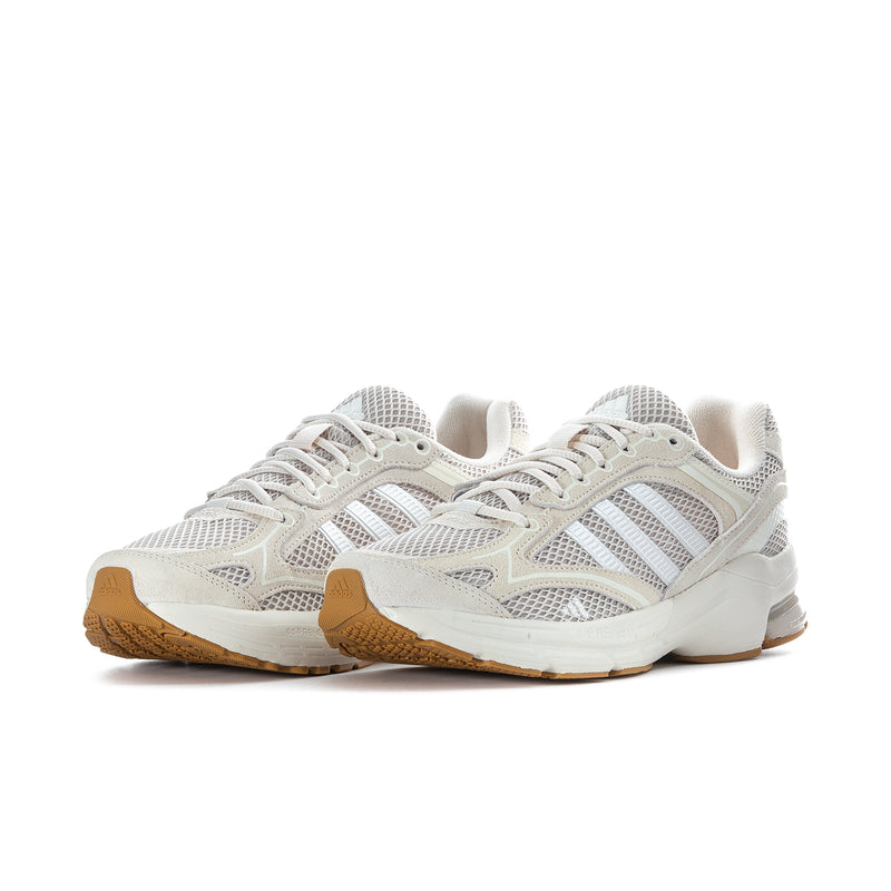 Women's sneakers side view in white with gray accents, lace-up mesh upper and gum outsole