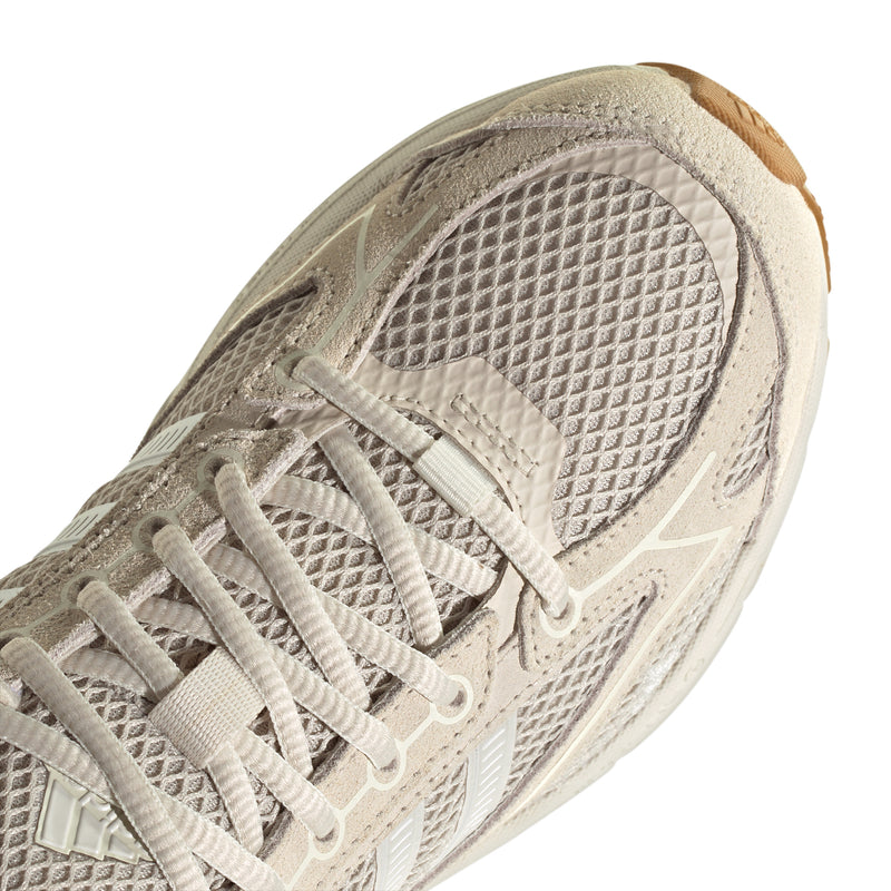 Close-up of women's sneaker toe in white mesh with lace overlay and breathable texture