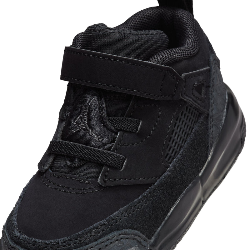Close-up of black toddler sneaker upper with suede paneling and hook-and-loop strap