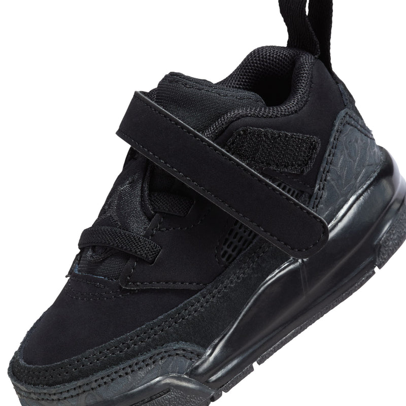 Side close-up of black toddler sneaker with strap, mesh detailing, and molded midsole