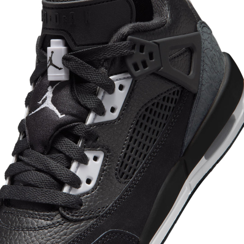 Close-up of youth black sneakers with laces, mesh quarter panel, and Jumpman tag