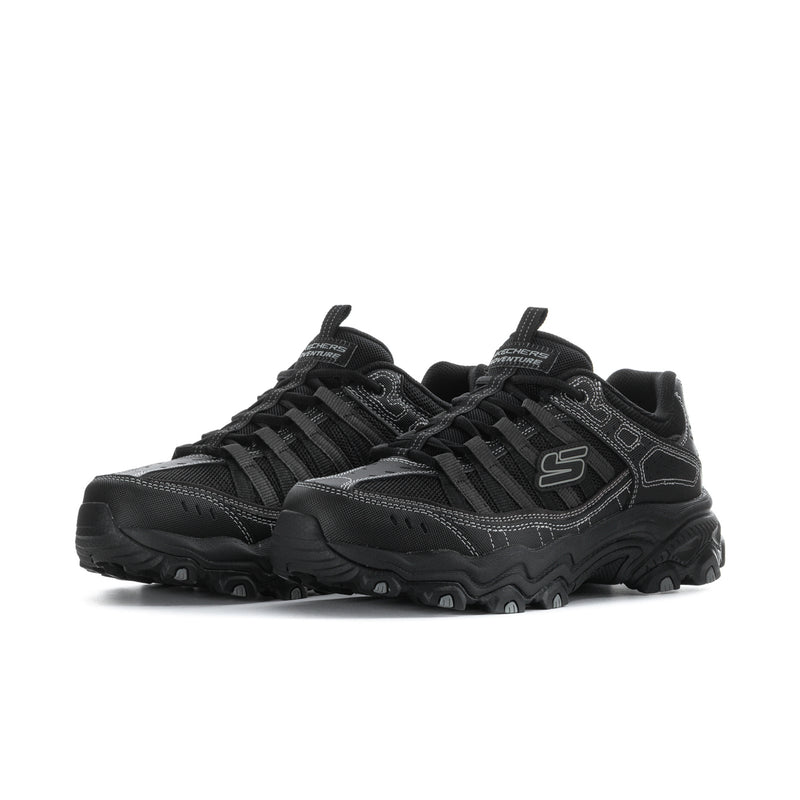 Men's black athletic sneakers, side view with S logo and textured panel details
