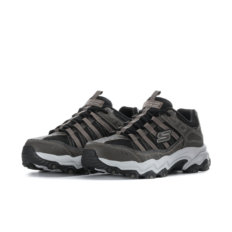 Men's wide athletic sneaker in brown and black, side view with striped lace pattern and sole