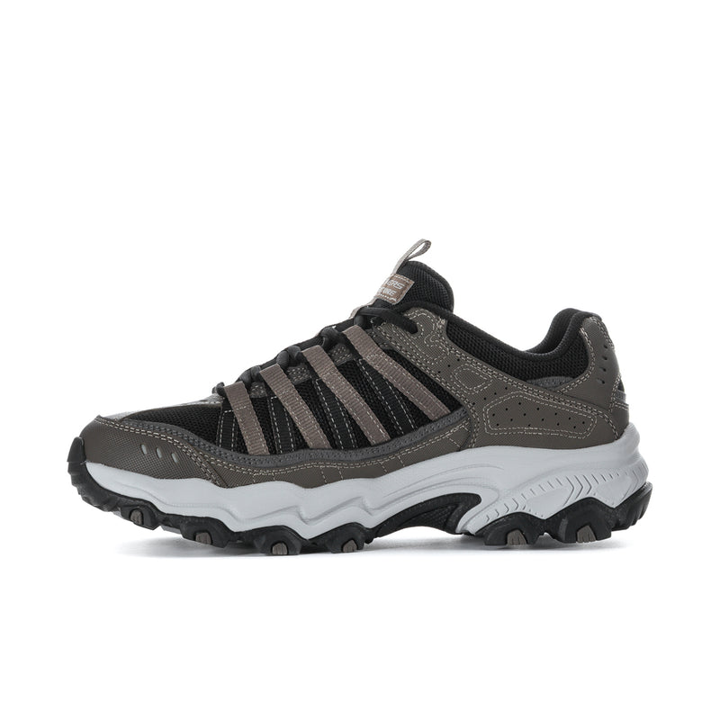 Men's wide athletic sneaker in brown and black, front-side view with lace-up and rugged sole