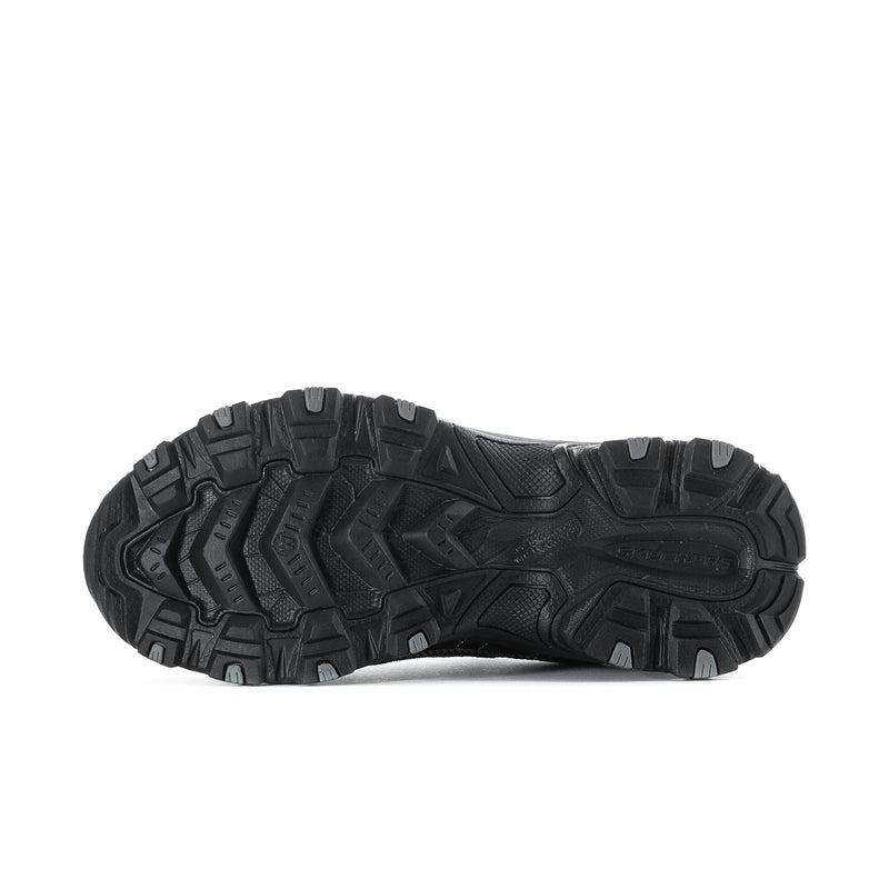 Men's black sneakers outsole view with deep traction tread pattern