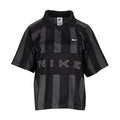 Black striped jersey polo with pointed collar, Nike swoosh, and NIKE lettering