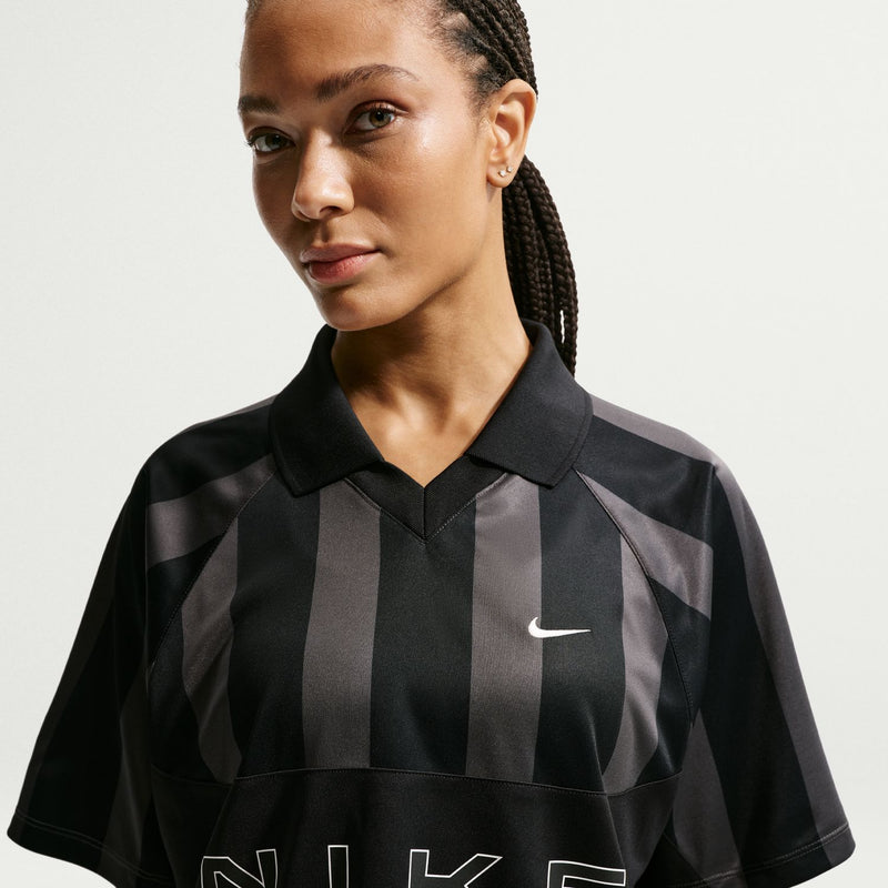 Women’s black striped jersey polo with pointed collar and Nike swoosh at chest