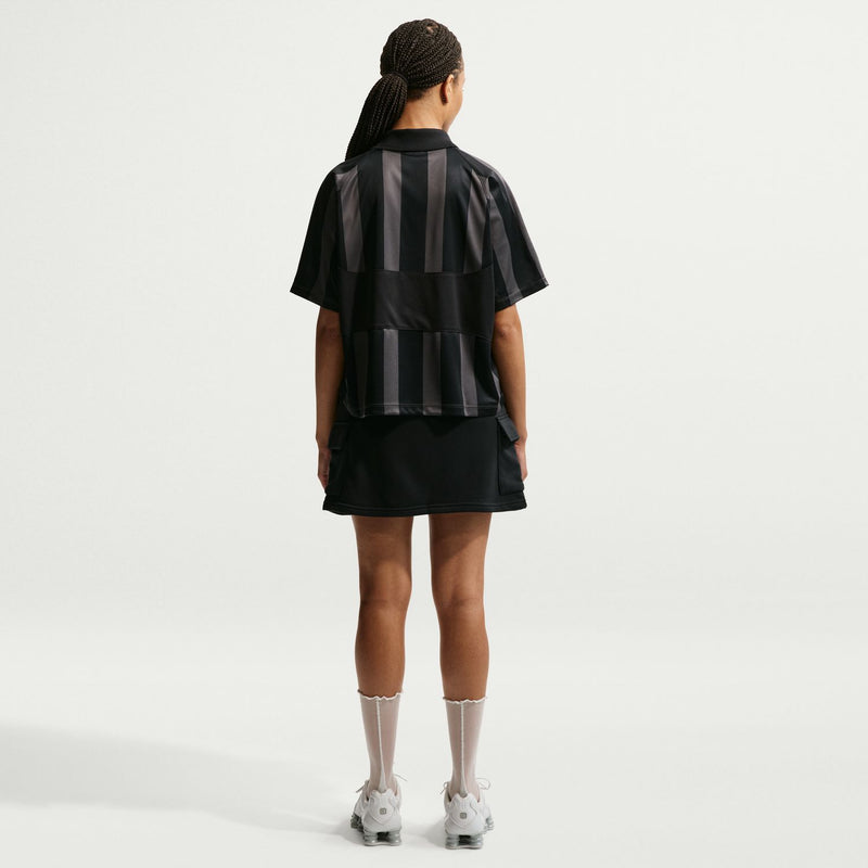 Women’s black striped jersey polo with back yoke panel and short sleeves